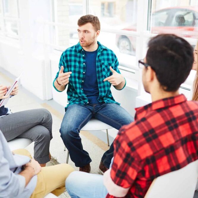 man talking in a group